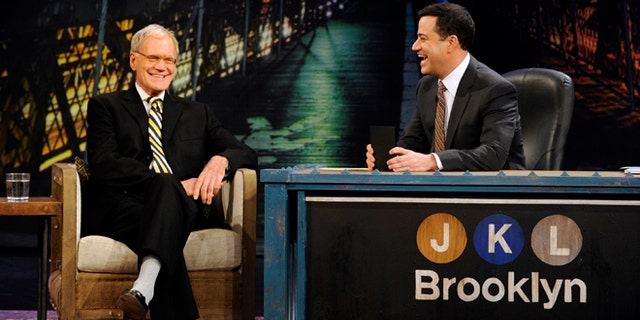 In this Oct. 31, 2012 photo released by ABC, host Jimmy Kimmel, right, speaks with guest David Letterman during "Jimmy Kimmel Live," in the Brooklyn borough of New York. New York's late-night TV hosts were back in swing, though, with all resuming regular production Wednesday. Kimmel, who usually broadcasts from Los Angeles, is doing a week of shows in Brooklyn.