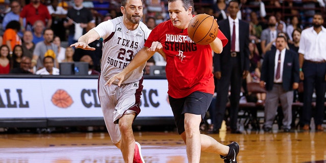 Senator Ted Cruz dribbles past Jimmy Kimmel during the Blobfish Basketball Classic and one-on-one interview at Texas Southern University's Health & Physical Education Arena Saturday, June 16, 2018 in Houston. Cruz challenged Kimmel to the game after Kimmel blamed the Houston Rockets playoff loss on the senator. Cruz won 11-9. (Michael Ciaglo/Houston Chronicle via AP)