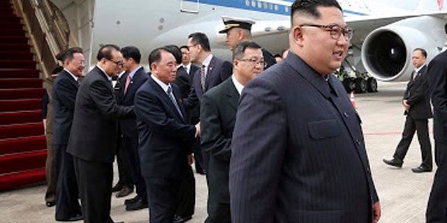 North Korean leader Kim Jong Un, right, arrives at the Changi International Airport, in Singapore, June 10, 2018.