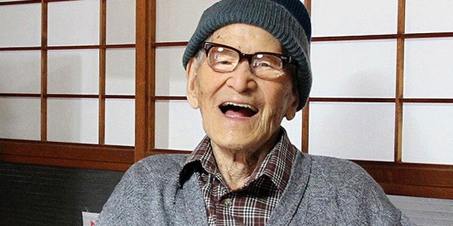 Oct. 15, 2012: Jiroemon Kimura smiles after he was presented with the certificate of the world's oldest living man from Guinness World Records Editor-in-Chief Craig Glenday at his home in the city, Kyoto Prefecture, Japan. (AP)