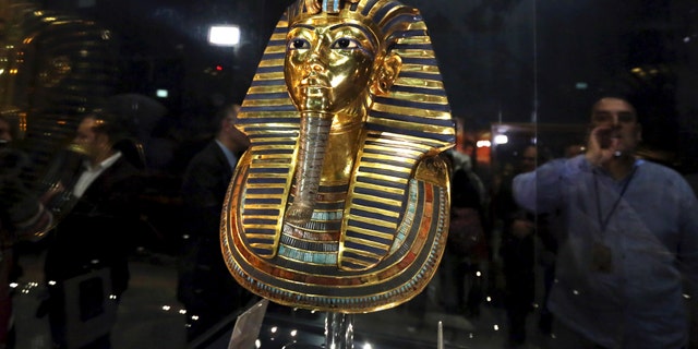 The golden mask of King Tutankhamun is displayed inside a glass cabinet at the Egyptian Museum in Cairo, Egypt, Dec. 16, 2015.