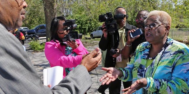 April 23, 2015: Kinloch city attorney James Robinson, left, asks Kinloch Mayor-elect Betty McCray if he can show the impeachment papers to the media at the Kinloch City Hall, in Kinloch, Mo. (AP_