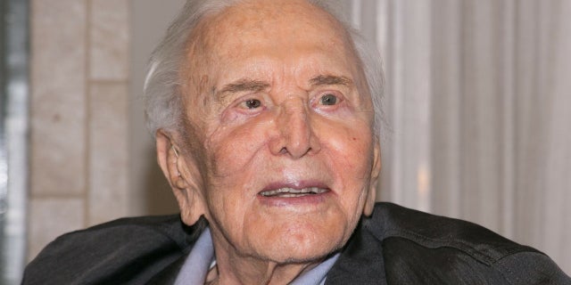 A generational photo shows Hollywood legend Kirk Douglas smiling down at his 8-month-old granddaughter.