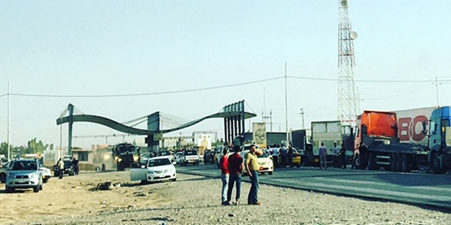 Trucks line up at a checkpoint to enter Kirkuk, following Friday's attack.
