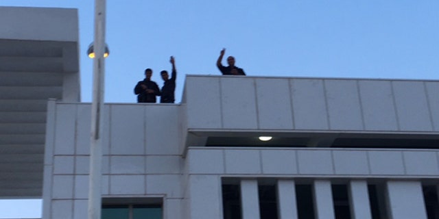 Kurdish forces keep watch atop buildings following the sleeper cell attack.