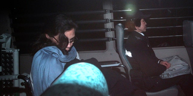 March 24: Nancy Kissel, left, an American woman accused of killing her husband, leaves the High Court by a prison van in Hong Kong. A Hong Kong jury is deliberating in the retrial of Kissel accused of murdering her wealthy husband after drugging his milkshake. (AP)