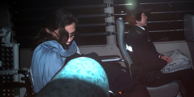 March 24: Nancy Kissel, left, an American woman accused of killing her husband, leaves the High Court by a prison van in Hong Kong. A Hong Kong jury is deliberating in the retrial of Kissel accused of murdering her wealthy husband after drugging his milkshake. (AP)