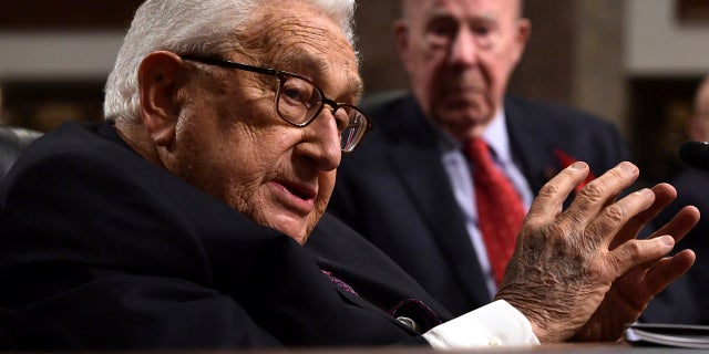 Former U.S. Secretary of State Henry Kissinger addresses the Senate Armed Services Committee, Jan. 25, 2018, with former U.S. Secretary of State George Shultz in the background. (Associated Press)