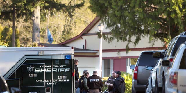 March 28, 2015: Kitsap County Sheriffs deputies and detectives gather to investigate the early Saturday morning shooting of three people, two fatal, at the Kariotis Community mobile home park off McWilliams Rd. in East Bremerton, Wash.