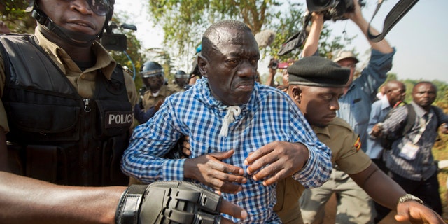 Feb. 22, 2016: Uganda's main opposition leader Kizza Besigye, center, is arrested by police and thrown into the back of a blacked-out police van which whisked him away and was later seen at a rural police station, outside his home in Kasangati, Uganda.