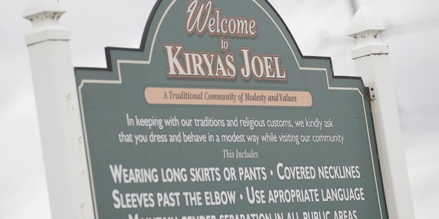 A sign at the entrance of the Hasidic village of Kiryas Joel in New York informs visitors of the dress code and gender separation rules.