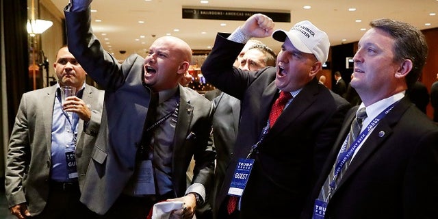 Members of the National Border Patrol Council cheer for President Trump during Election Day.