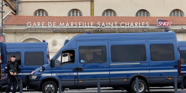 Police vans are parked outside Marseille Saint Charles train station a day after a man fatally stabbed two women outside the train station in Marseille, France, Oct. 2, 2017.