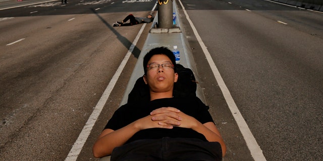 Oct. 8: A pro-democracy supporter sleeps on the streets in the occupied areas surrounding the government complex in Hong Kong.
