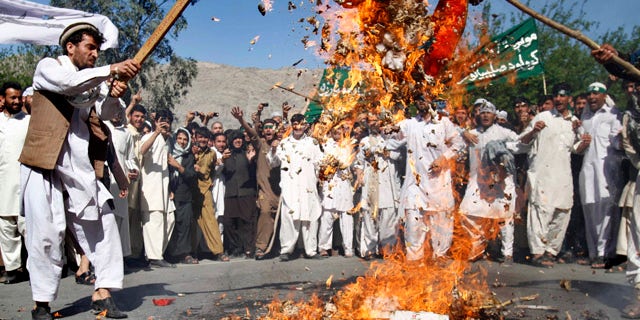 April 3, 2011: Afghan protestors burn an effigy of U.S. President Barack Obama during a demonstration in Jalalabad, Afghanistan. Afghan protests against the burning of a Koran in Florida entered a third day with a demonstration in the major eastern city Sunday, while the Taliban called on people to rise up, blaming government forces for any violence.