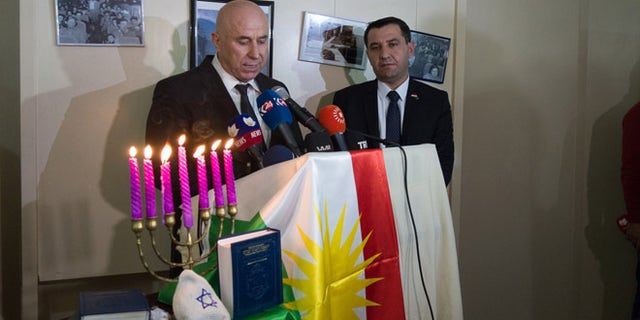 Nevzat Hadi, mayor of Erbil, addresses Kurdish Jews Friday as Sherzad Omer Mamsani looks on.