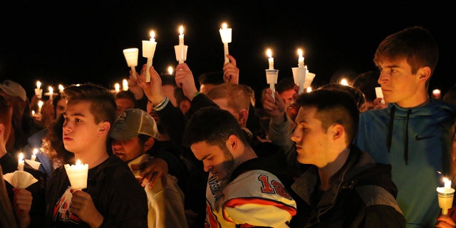 People attend a vigil for the victims of a fatal shooting at Marshall County High School on Thursday, Jan. 25, 2018, at Mike Miller County Park in Benton, Ky.
