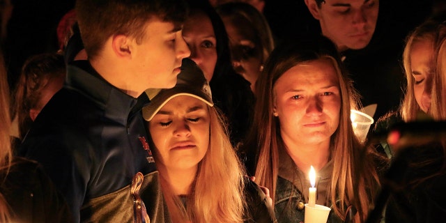 People attend a vigil for the victims of a fatal shooting at Marshall County High School on Thursday, Jan. 25, 2018, at Mike Miller County Park in Benton, Ky.