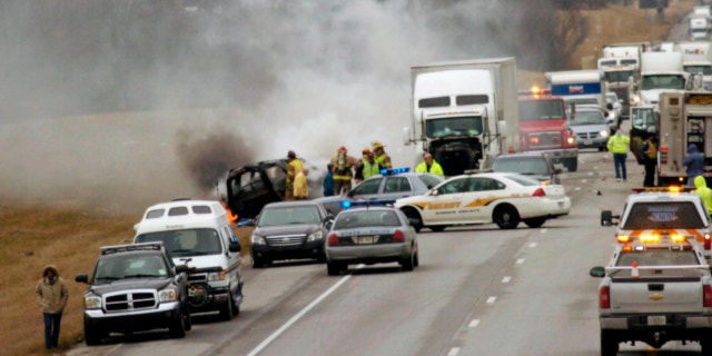 March 2, 2013: Emergency personnel work at the scene of a multi-vehicle wreck on Interstate 65 near the 82 mile marker north of Sonora, Ky.