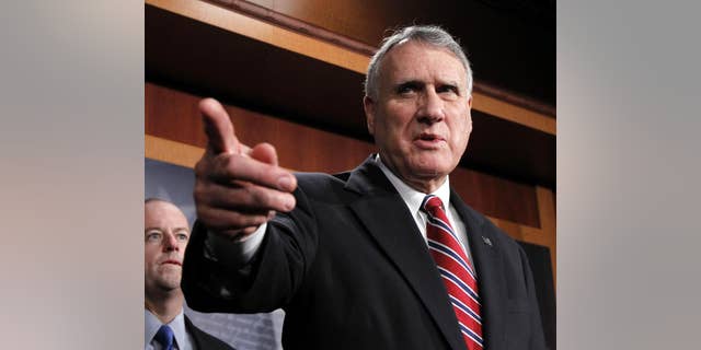 Senate Minority Whip Jon Kyl of Ariz., left, accompanied by Sen. George LeMieux, R-Fla., gestures during a news conference on Capitol Hill in Washington, Wednesday, Dec. 15, 2010. (AP Photo)