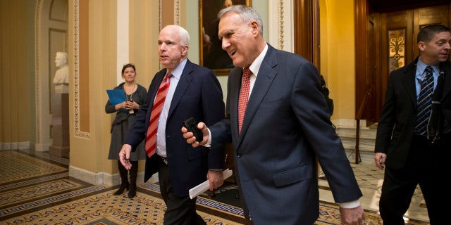 In this Dec. 30, 2012, file photo, Sen. John McCain, R-Ariz., left, and then-Senate Minority Whip Jon Kyl, R-Ariz., leave the chamber as the Senate.