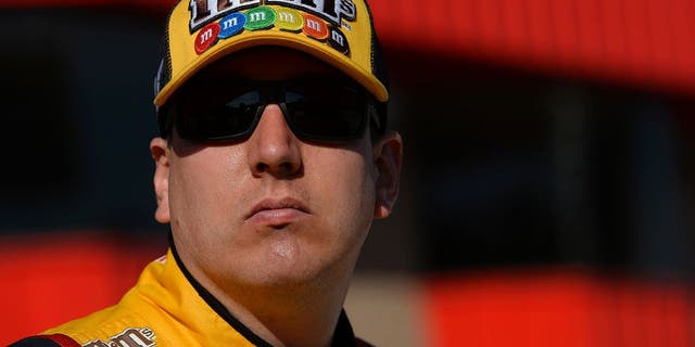 FONTANA, CA - MARCH 18: Kyle Busch, driver of the #18 M&M's 75 Toyota, stands on the grid during qualifying for the NASCAR Sprint Cup Series Auto Club 400 at Auto Club Speedway on March 18, 2016 in Fontana, California. (Photo by Robert Laberge/Getty Images)