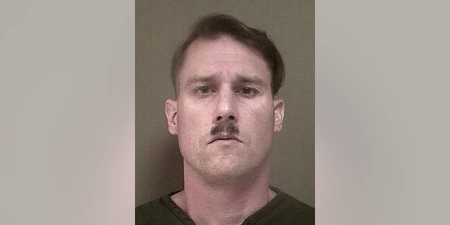 This photo provided Monday May 16, 2016 by New Jersey's Ocean County Jail shows Bruce Post III, who was arrested by Lacey, N.J., police on Sunday, May 15, 2016 after authorities ay they found a large cache of weapons and ammunition in the New Jersey Pinelands.