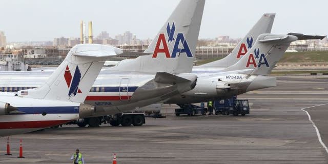 FILE: April 16, 2013: American Airlines aircraft sit on the tarmac at LaGuardia airport in New York. The FBI said Oct. 18 it has assigned its Joint Terrorism Task Force to lead a probe of recent laser attacks on the cockpits of two planes approaching the airport.