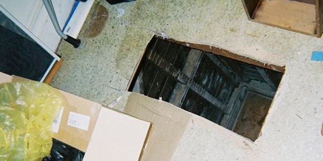 UNDATED: This photo released by the San Francisco Office of the District Attorney show a hole cut into the floor of a San Francisco apartment.