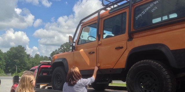 Attorney Christina Clodfelter watches as her client Jennifer Brinkley is reunited with her Land Rover Defender. Federal authorities had seized the vehicle last summer. (Fox News)