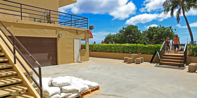 In this Monday, Aug. 20, 2018 photo, sandbags are seen near a stairway at the west end of the Sheraton Waikiki hotel in Honolulu in preparation for Hurricane Lane.