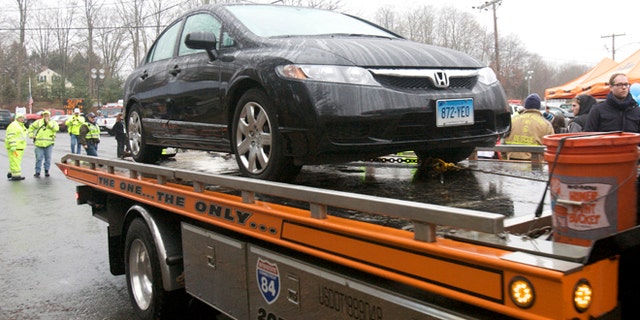 Dec. 16, 2012: The car driven by Connecticut school shooter Adam Lanza is towed from Sandy Hook Elementary School in Newtown, Conn.