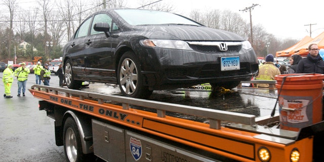 Dec. 16, 2012: The car driven by Connecticut school shooter Adam Lanza is towed from Sandy Hook Elementary School in Newtown, Conn.