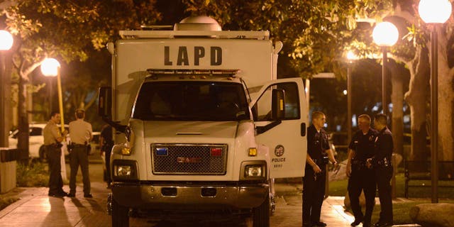 LOS ANGELES, CA - NOVEMBER 01: Los Angeles Police Department officers and USC Department of Public Safety officer gather at the command post after four people were shot including one in critical condition during a Halloween party at the Tutor Campus Center on November 1, 2012 in Los Angeles, California. The university issued an alert to students and staff that the police were investigating an incident and requested the campus be shut down while encouraging others to stay away from the area to further notice. (Photo by Kevork Djansezian/Getty Images)