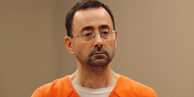 Dr. Larry Nassar, 54, appears in court for a plea hearing in Lansing, Mich.