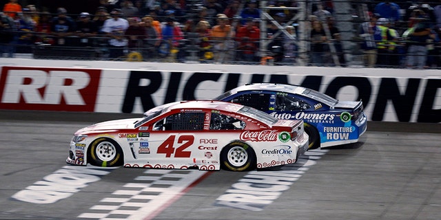 Kyle Larson (42) passes Martin Truex, Jr., (78) on the final restart to win the NASCAR Cup Series auto race at Richmond International Raceway in Richmond, Va., Saturday, Sept. 9, 2017. (AP Photo/Steve Helber)