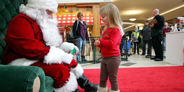 Dec. 23, 2010: Emma Schlichtmann, 3, of Potosi, Wis., tells Santa all the things she wants for Christmas while visiting him at a shopping mall in Dubuque, Iowa.