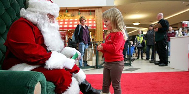 Dec. 23, 2010: Emma Schlichtmann, 3, of Potosi, Wis., tells Santa all the things she wants for Christmas while visiting him at a shopping mall in Dubuque, Iowa.