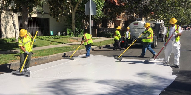 Officials in Los Angeles are painting streets white to reduce the effect of urban "heat islands."