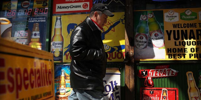UNION CITY, NJ - MARCH 28: A man walks by adds in Spanish outside of a bodega on March 28, 2011 in Union City, New Jersey. Union City New Jersey, one of the stateÂs largest cities, has a population of Hispanic or Latino origin of over 80%. According to the new 2010 Census Bureau statistics reported last Thursday, the Hispanic population in the United States has grown by 43% in the last decade, surpassing 50 million and accounting for about 1 out of 6 Americans. (Photo by Spencer Platt/Getty Images)