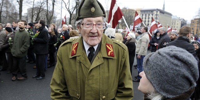 An elderly Latvian takes part in a ceremony to honor soldiers who fought in a Waffen SS unit during World War II, in Riga, Latvia, last year. (AP/Roman Koksarov)