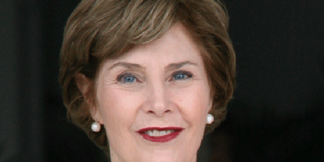 In this Nov. 21, 2008, file photo, first lady Laura Bush, left, stands at the presidential palace in Panama City. (AP)