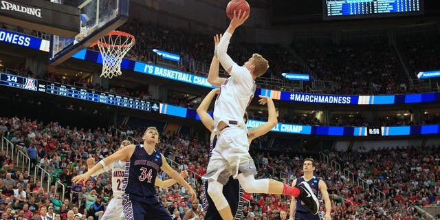 Arizona forward Lauri Markkanen (10) shoots the ball as Saint Mary's center Jock Landale (34) blocks out for the rebound during the first half of a second-round college basketball game in the men's NCAA Tournament Saturday, March 18, 2017, in Salt Lake City. (AP Photo/George Frey)