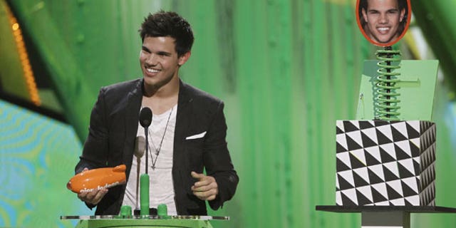 March 27: Taylor Lautner accepts the award for favorite movie actor at Nickelodeon's 23rd Annual Kids' Choice Awards. (AP)