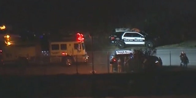 Authorities respond after a man climbed a fence at LAX in Los Angeles and ran towards a plane on a runway.