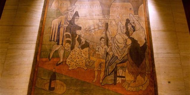 FILE- In this Feb. 28, 2014, file photo provided by the New York Landmarks Conservancy, a stage curtain painted by Pablo Picasso hangs on a wall at the Four Seasons restaurant in New York. The 19-by-20-foot curtain, called "Le Tricorne," is being donated to the New-York Historical Society, painting owner the Landmarks Conservancy said on Thursday, June 12, 2014. The curtain was at the center of a legal dispute between the restaurants landlord, who wanted it moved so the wall behind it can be repaired. (AP Photo/New York Landmarks Conservancy, Rick Bruner, File)