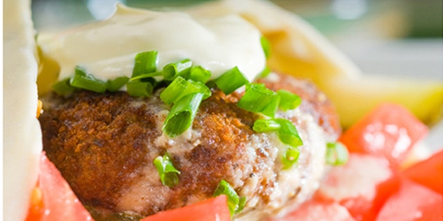 fresh traditional falafel wrap on pita bread with fresh chopped tomatoes