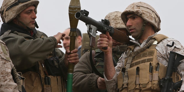 March 17, 2014: Lebanese army soldiers from a commandos unit, prepare to search an area where they blew up a bomb-packed parked car, in a field outside the village of Fakiha, near the Lebanese and Syria border, in northeast Lebanon.