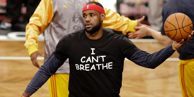 Cleveland Cavaliers' LeBron James wears a T-shirt reading "I Can't Breathe," protesting the death of Eric Garner while being arrested by NYPD officers, warms up before an NBA basketball game against the Brooklyn Nets in New York.