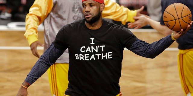 Cleveland Cavaliers' LeBron James wears a T-shirt reading "I Can't Breathe," protesting the death of Eric Garner while being arrested by NYPD officers, warms up before an NBA basketball game against the Brooklyn Nets in New York.